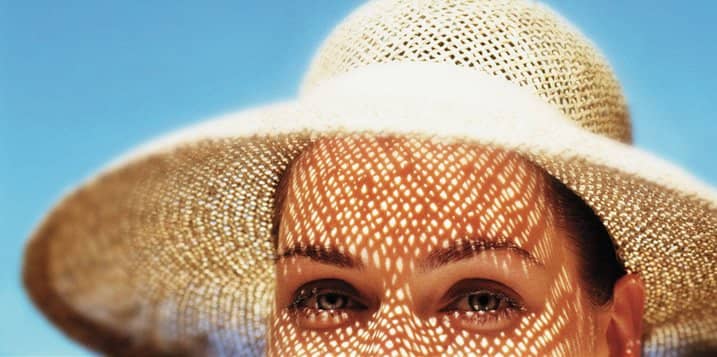 Lady with sun hat blue sky